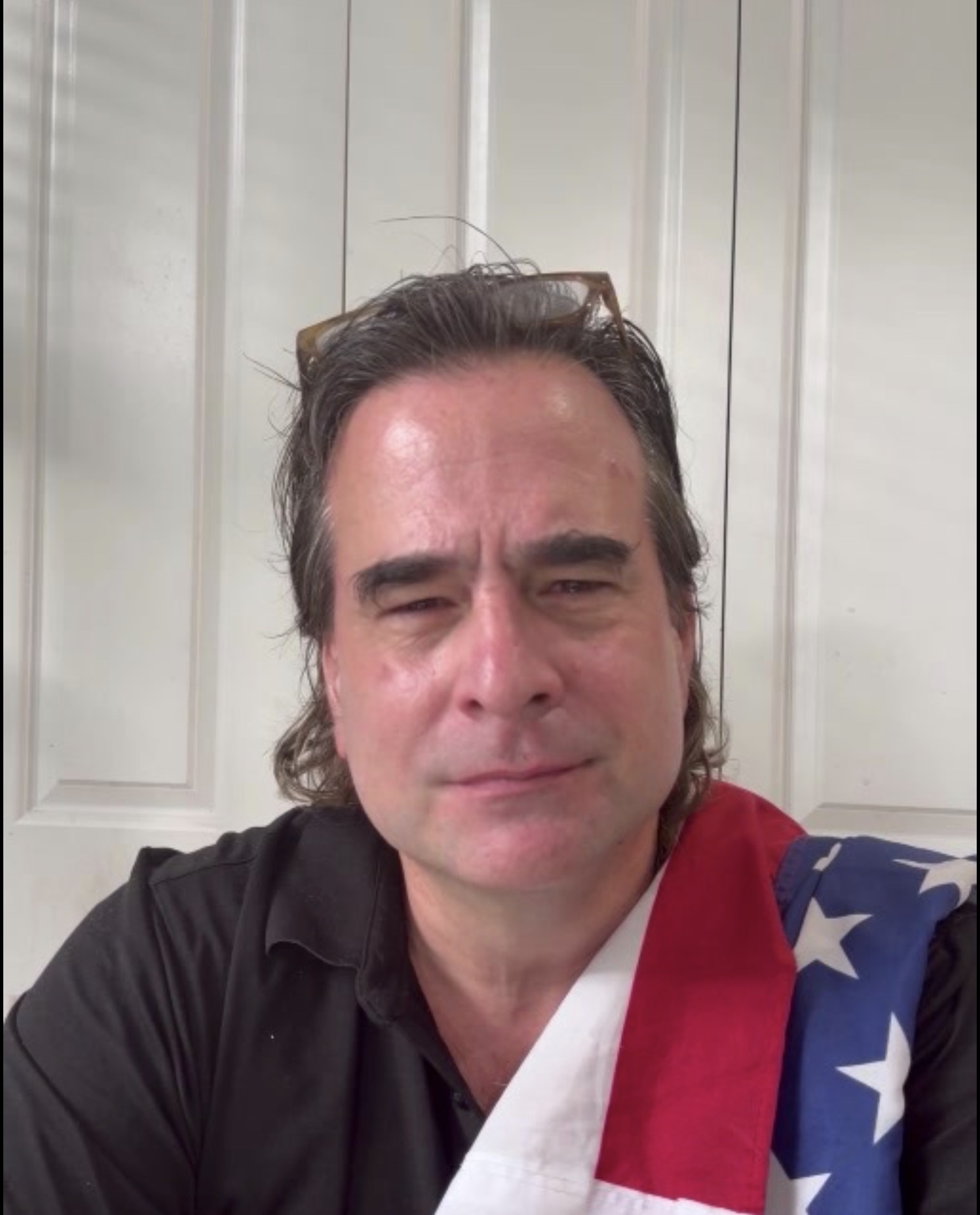Dr. Jeff Datto with an American flag draped over his shoulder